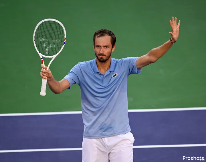 Medvedev waves racquet.