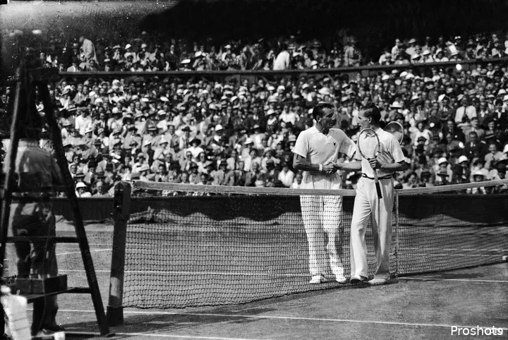 Fred Perry shakes hands at the net.