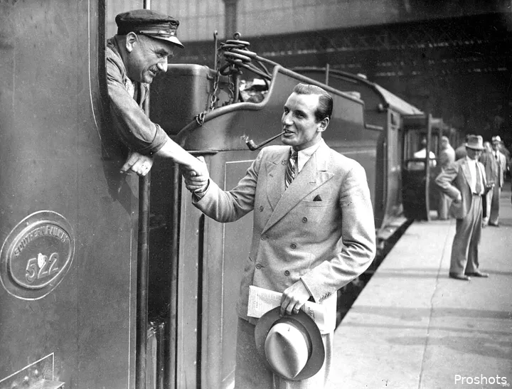 Fred Perry shakes hands.