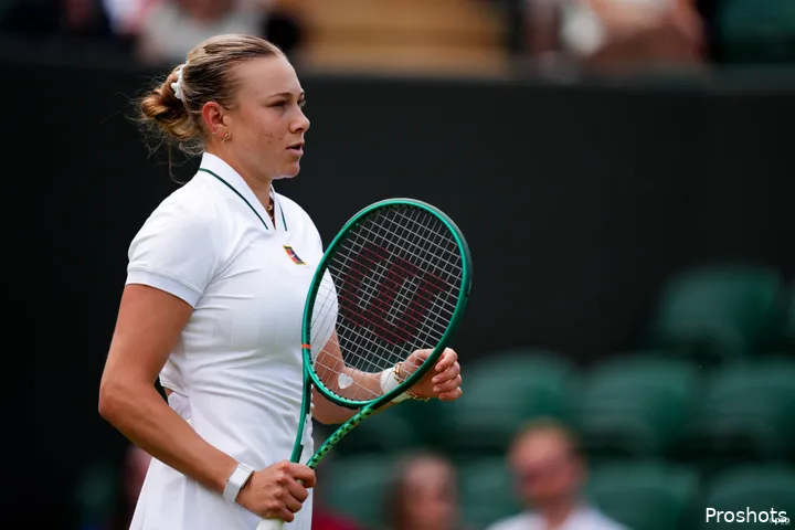 Anisimova looks on.
