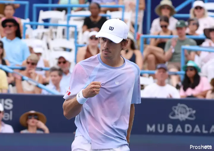 Alex de Minaur touches his shirt on the court during the DC Open.