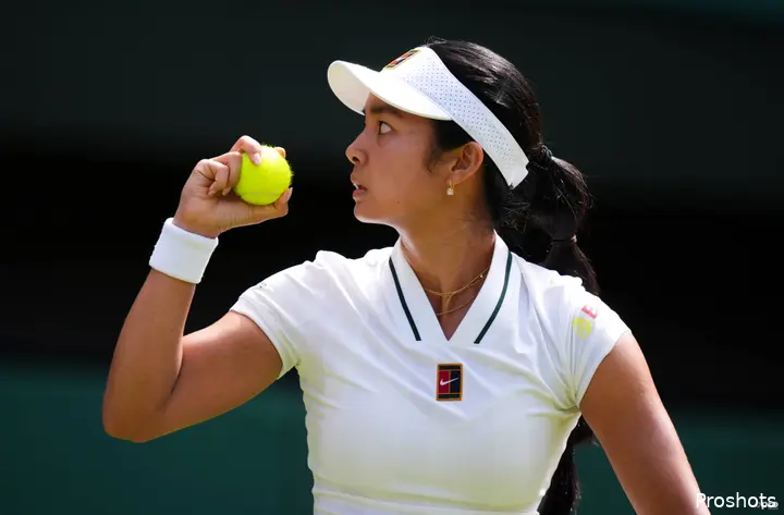 Alexandra Eala holds ball.