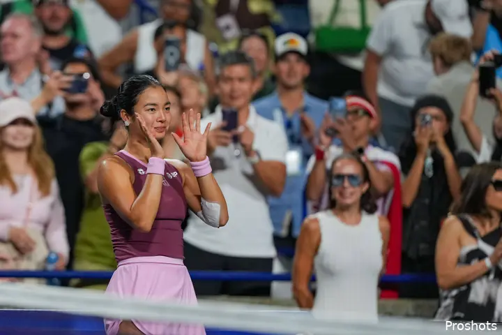 Alexandra Eala looks at crowd and claps.
