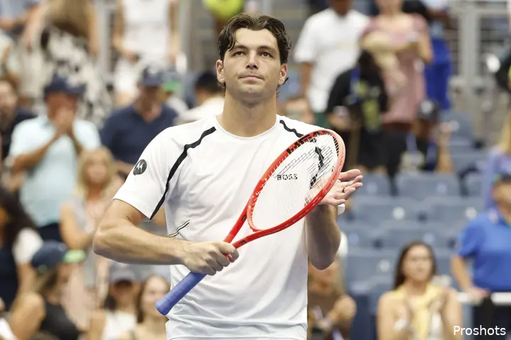 Taylor Fritz clapping with his racket.