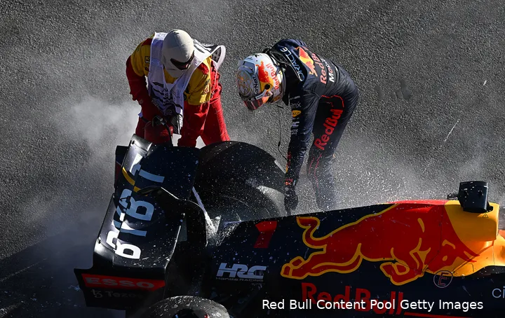 <i>Max Verstappen liet zich wanhopig uit over de situatie bij Red Bull Racing na twee DNFs in de eerste drie races. In deze foto helpt hij de marshal terwijl zijn bolide, voor het laatst dat jaar, geblust moest worden. (Foto: Red Bull Content Pool/Getty Images)</i>