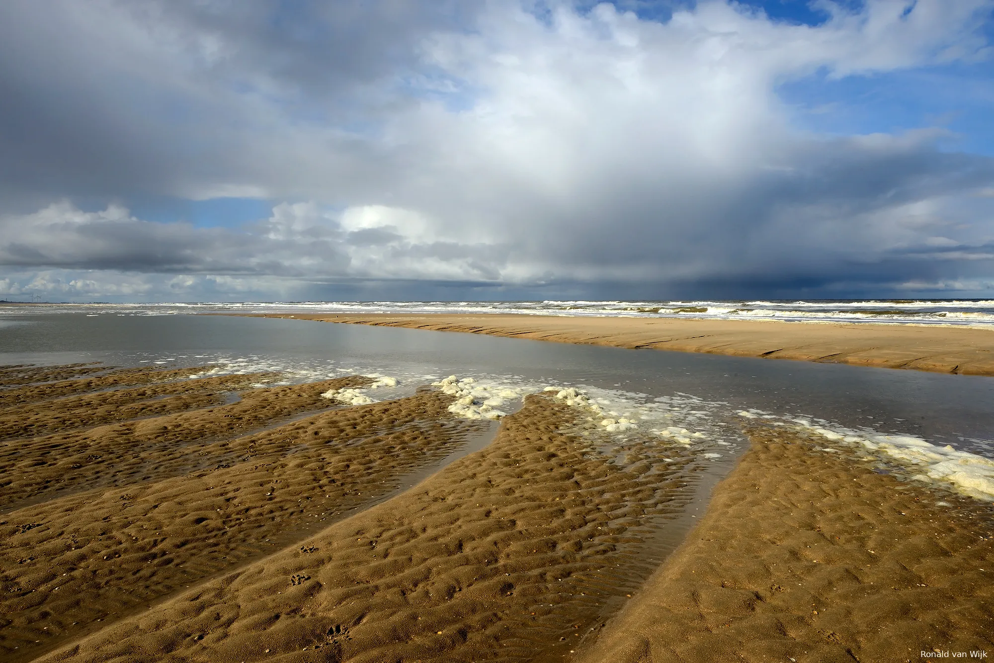 dreigende wolkenlucht boven zee op het strand van castricum door ronald van wijk