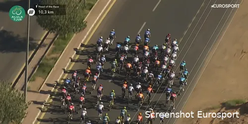 The DSM-Firmenich PostNL team (seen in the middle right of the image) makes a strategic move during the final stage of the AlUla Tour.