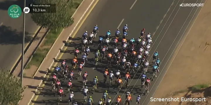 The DSM-Firmenich PostNL team (seen in the middle right of the image) makes a strategic move during the final stage of the AlUla Tour.