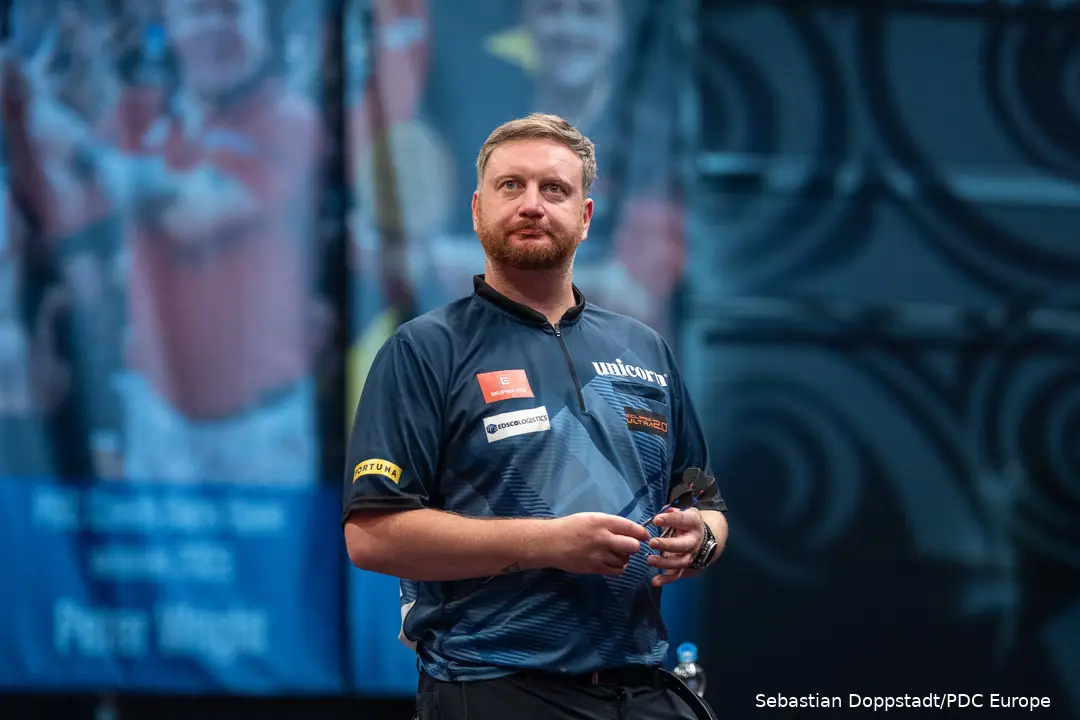 Cameron Menzies holds a dart.