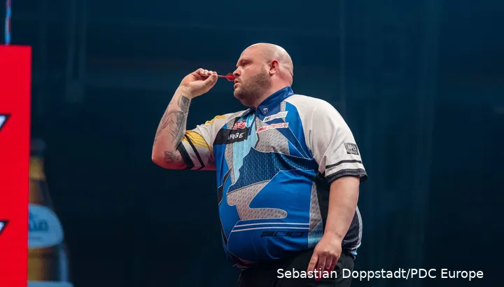 Adam Lipscombe throwing a dart.