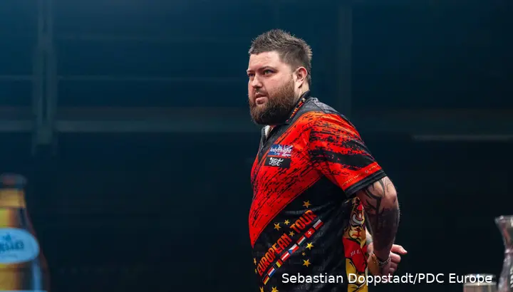 Michael Smith looks on.