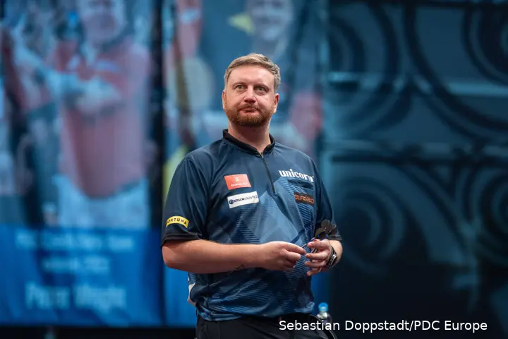 Cameron Menzies holds a dart.