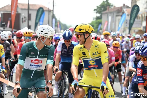 Mathieu van der Poel in the green jersey next to yellow jersey Jonathan Milan.
