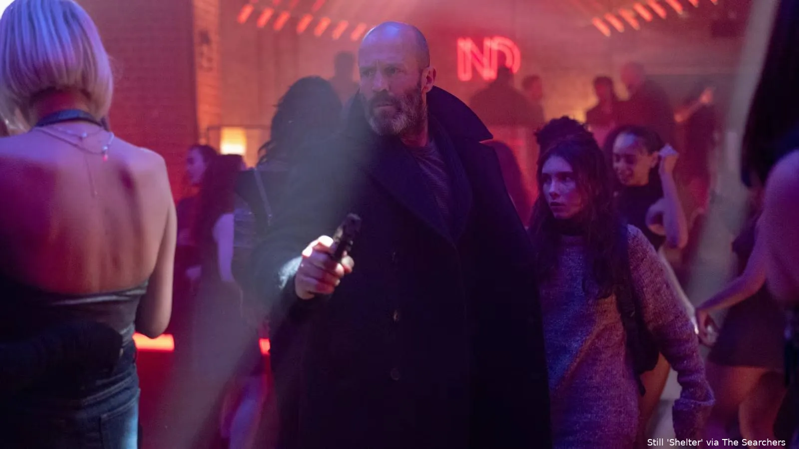 jason-statham-walks-through-a-crowd-with-a-little-girl-in-shelter