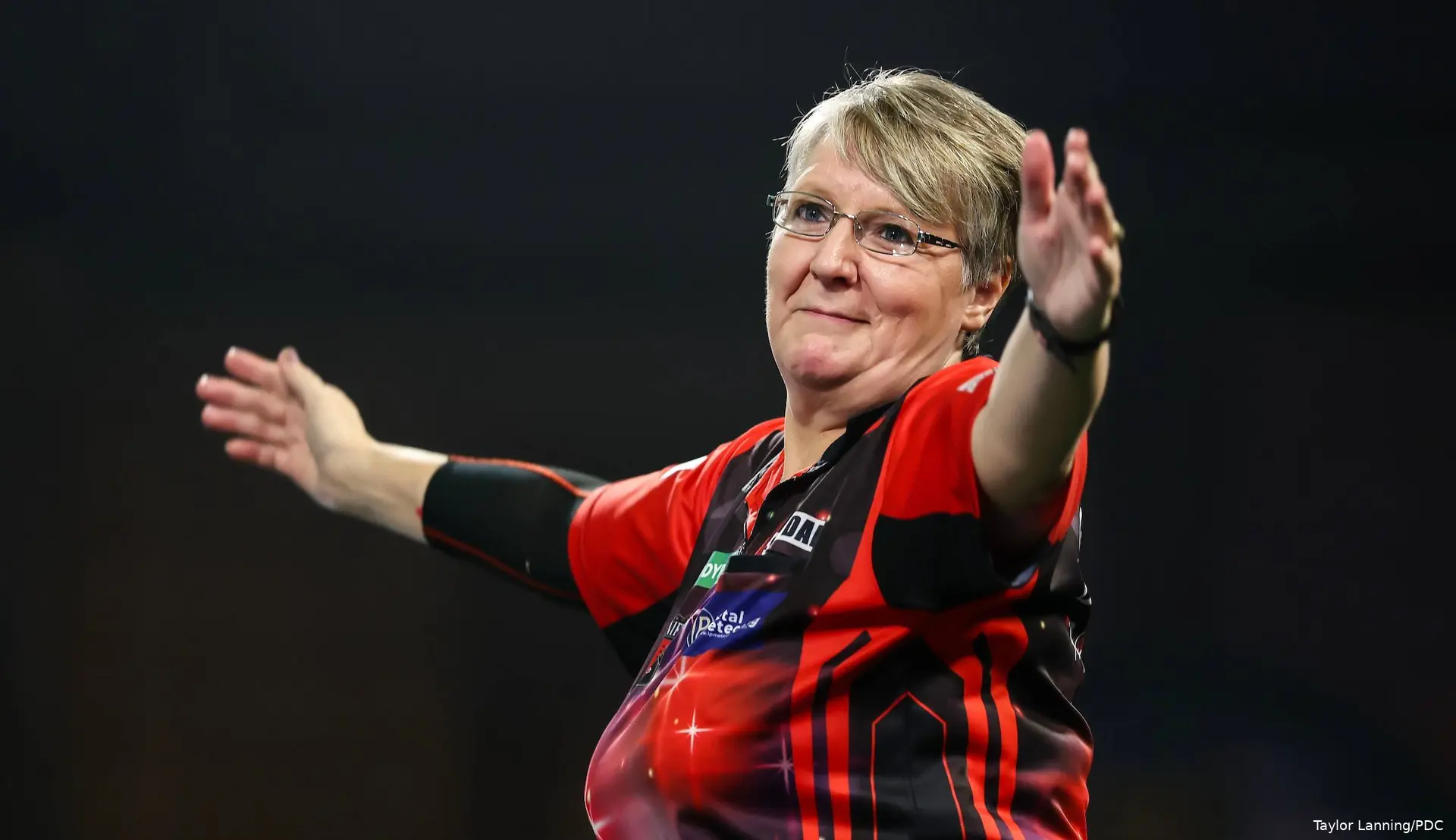 Lisa Ashton holds arms aloft.
