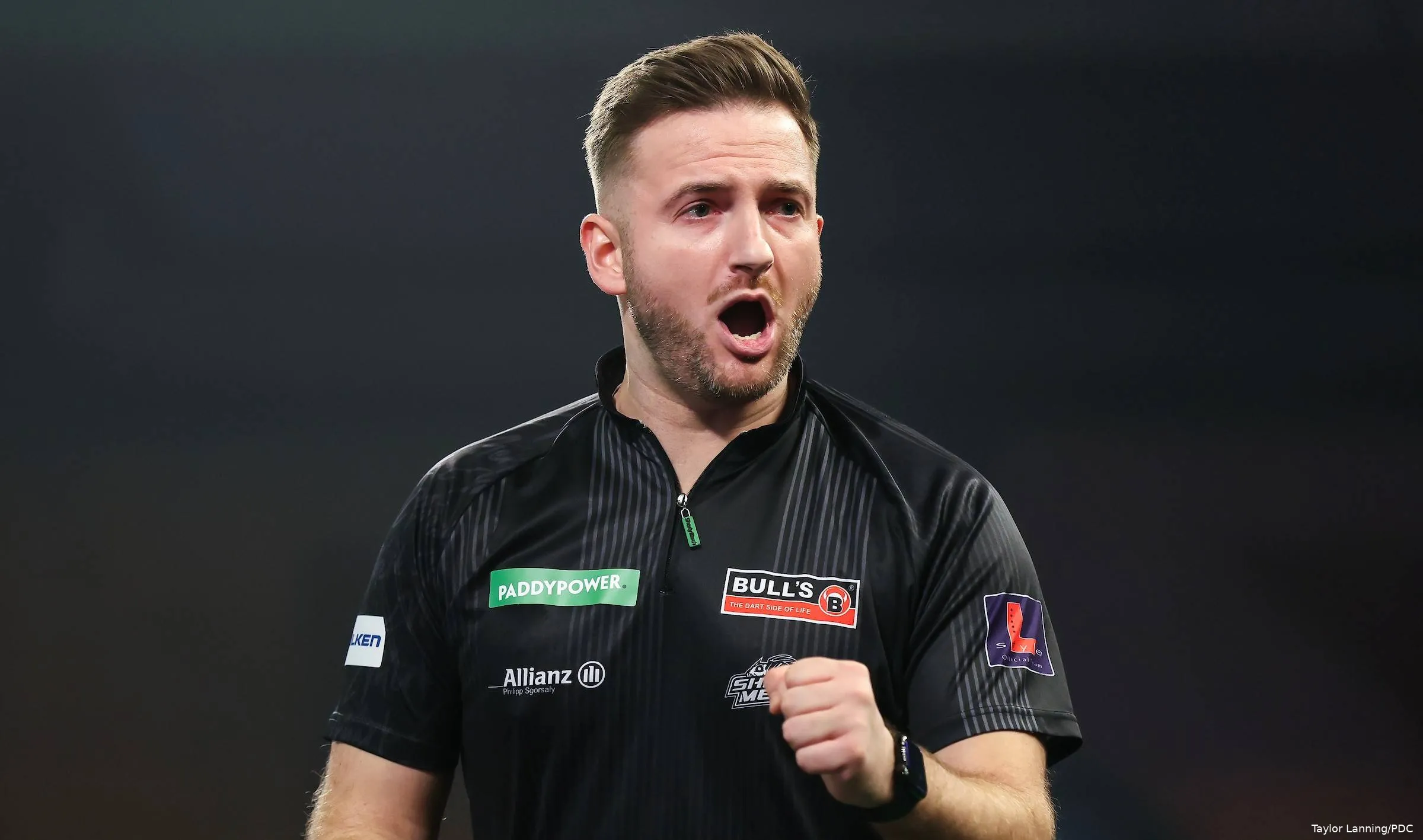 Arno Merk with mouth open celebrates winning leg.