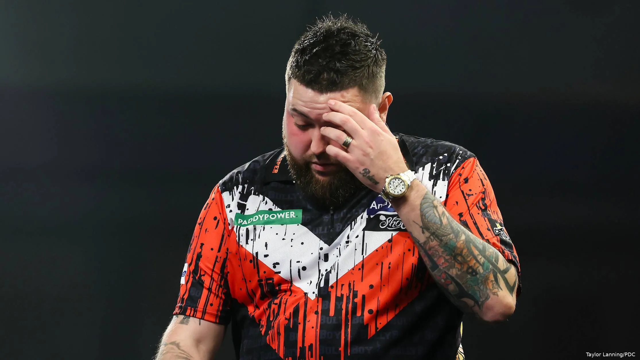 Michael Smith has head in his hands.