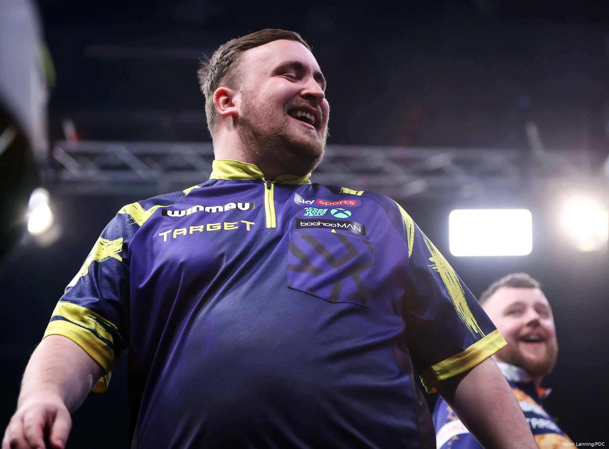 Luke Littler smiling with Josh Rock at the Winmau World Masters