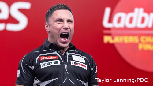 Gerwyn Price with mouth open celebrates in Minehead.