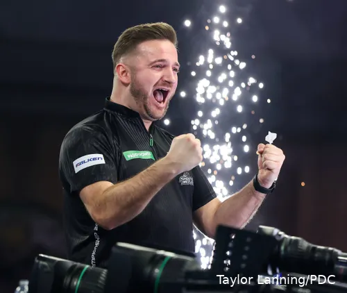 Arno Merk clenches fists celebrating in front of pyro.