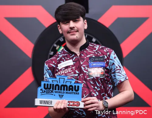 Kaya Baysal blickt mit Pokal in die Kamera.