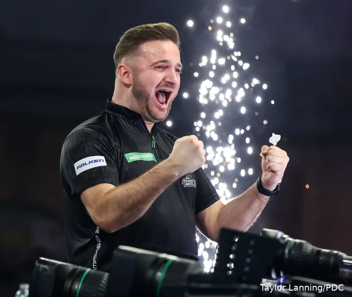 Arno Merk clenches fists celebrating in front of pyro.