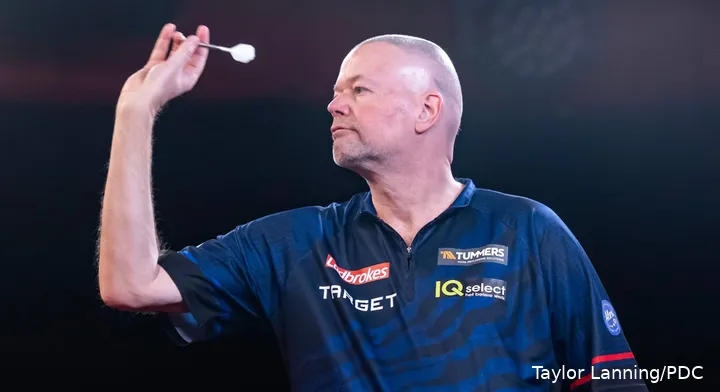 Raymond van Barneveld throws his dart at a board.
