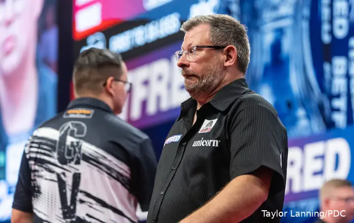 James Wade pulls a funny face as he walks past Gian van Veen.