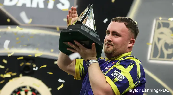 Luke Littler präsentiert seine Premier-League-Trophäe.