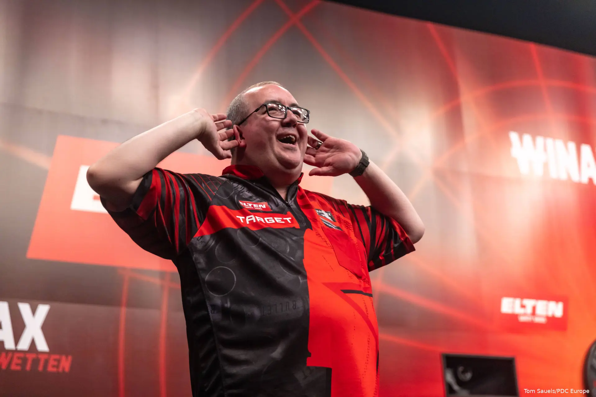 Stephen Bunting lifts his hands to his ears.