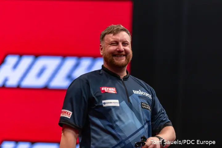 Cameron Menzies smiles on stage.