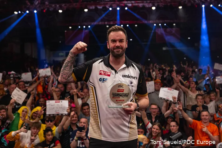 Ross Smith poses with the trophy after winning the 2026 International Darts Open