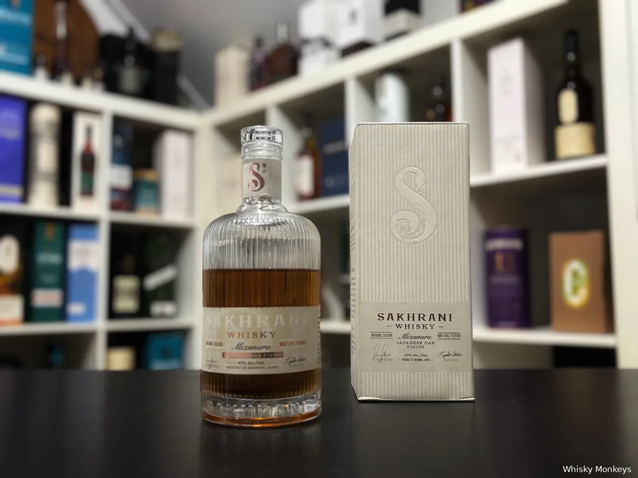 Sakhrani Mizunara Japanese Oak Finish whisky in front of a whisky cabinet