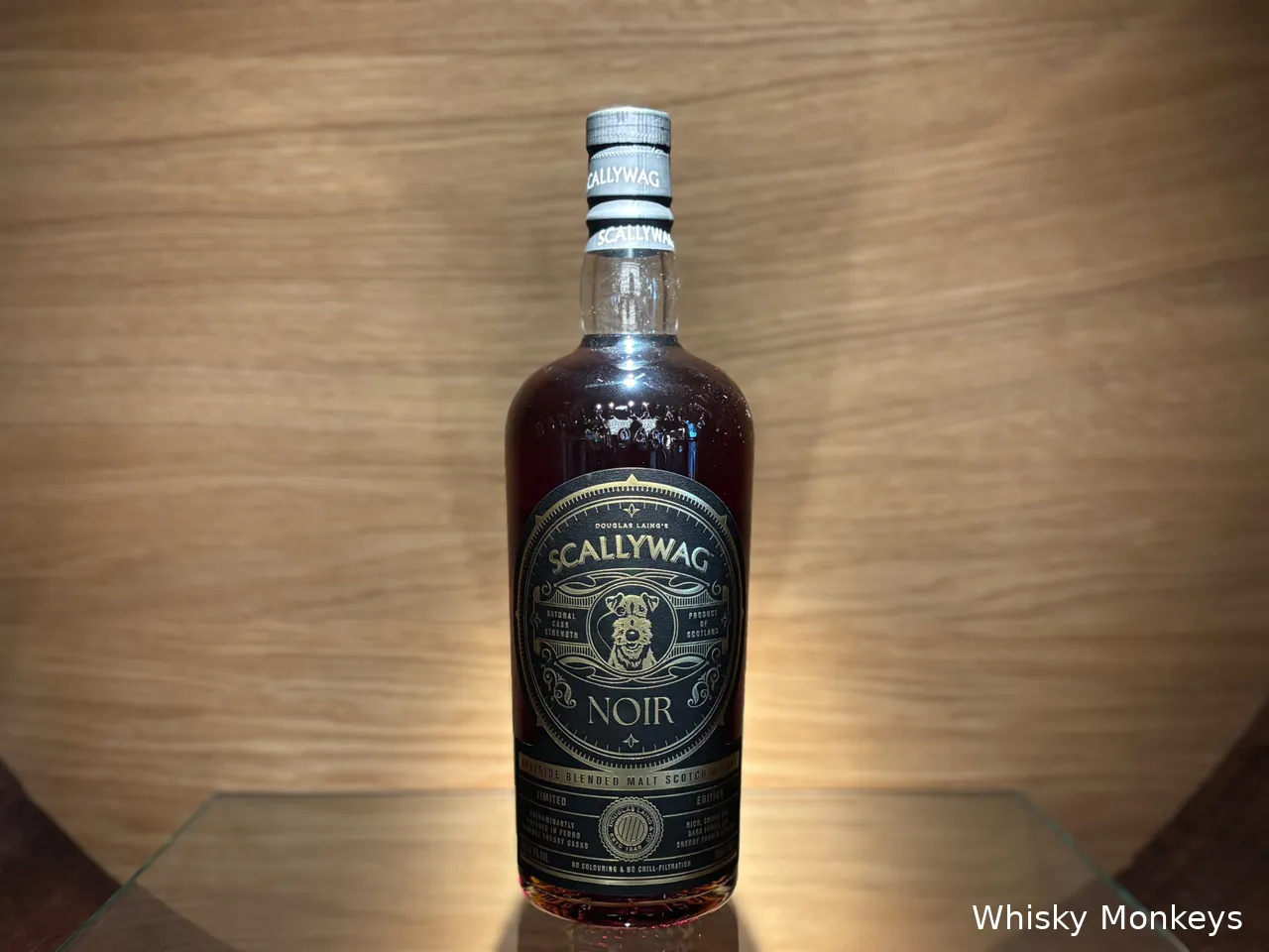 Scallywag Noir bottle in a whisky barrel