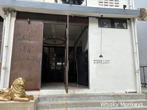 The entrance of Brass Lion Distillery is guarded by a lion