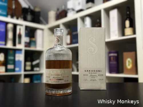 Sakhrani Mizunara Japanese Oak Finish whisky in front of a whisky cabinet