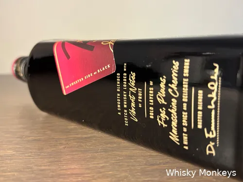 A bottle of Johnnie Walker Black Ruby whisky lying on a table