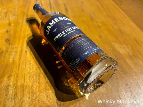 Close-up of label and glass with golden whiskey