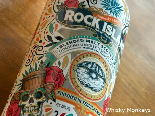 Pouring the whisky into a glass with light gold hue and slight legs