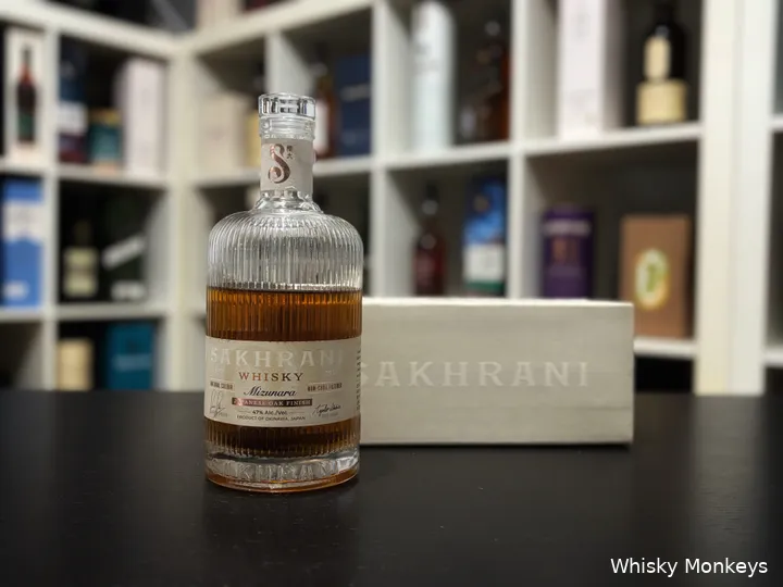 Sakhrani Mizunara Japanese Oak Finish whisky in front of a whisky cabinet