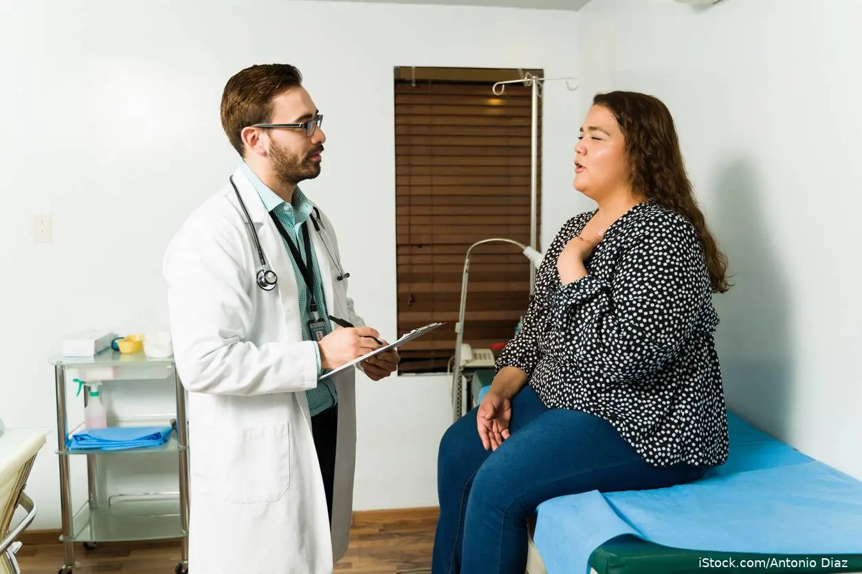 Doctor and obese female patient iStock-1389957277
