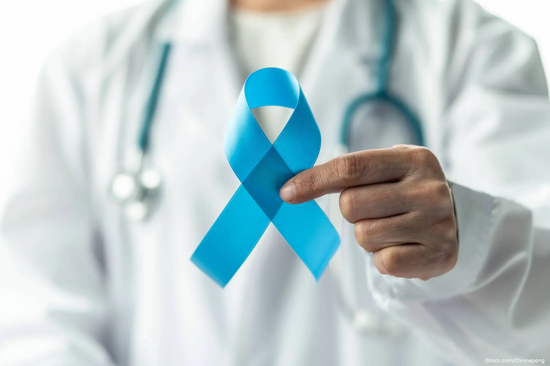 docter holding a blue ribbon for prostate cancer awareness