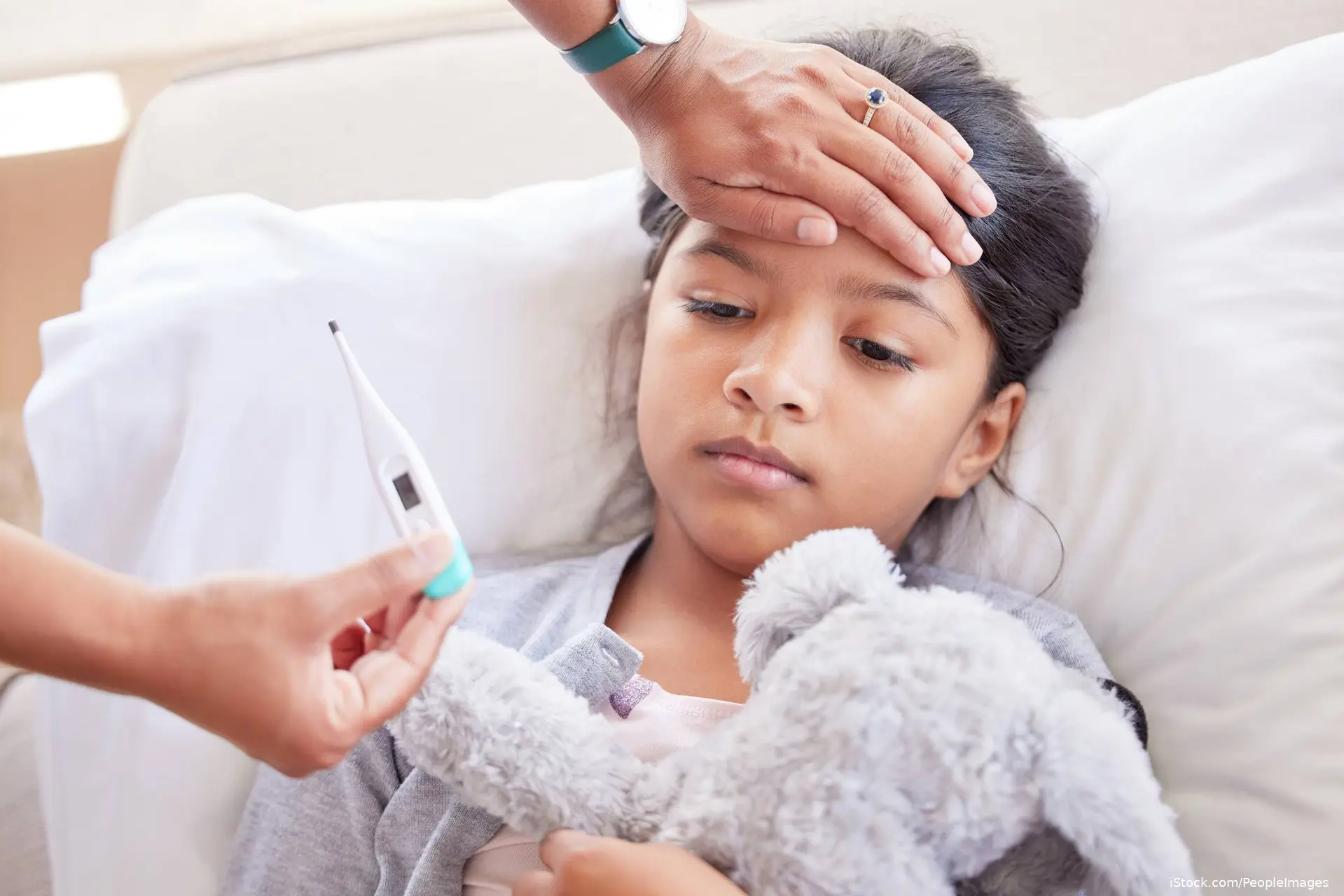 pediatric getting checked with thermometer for fever