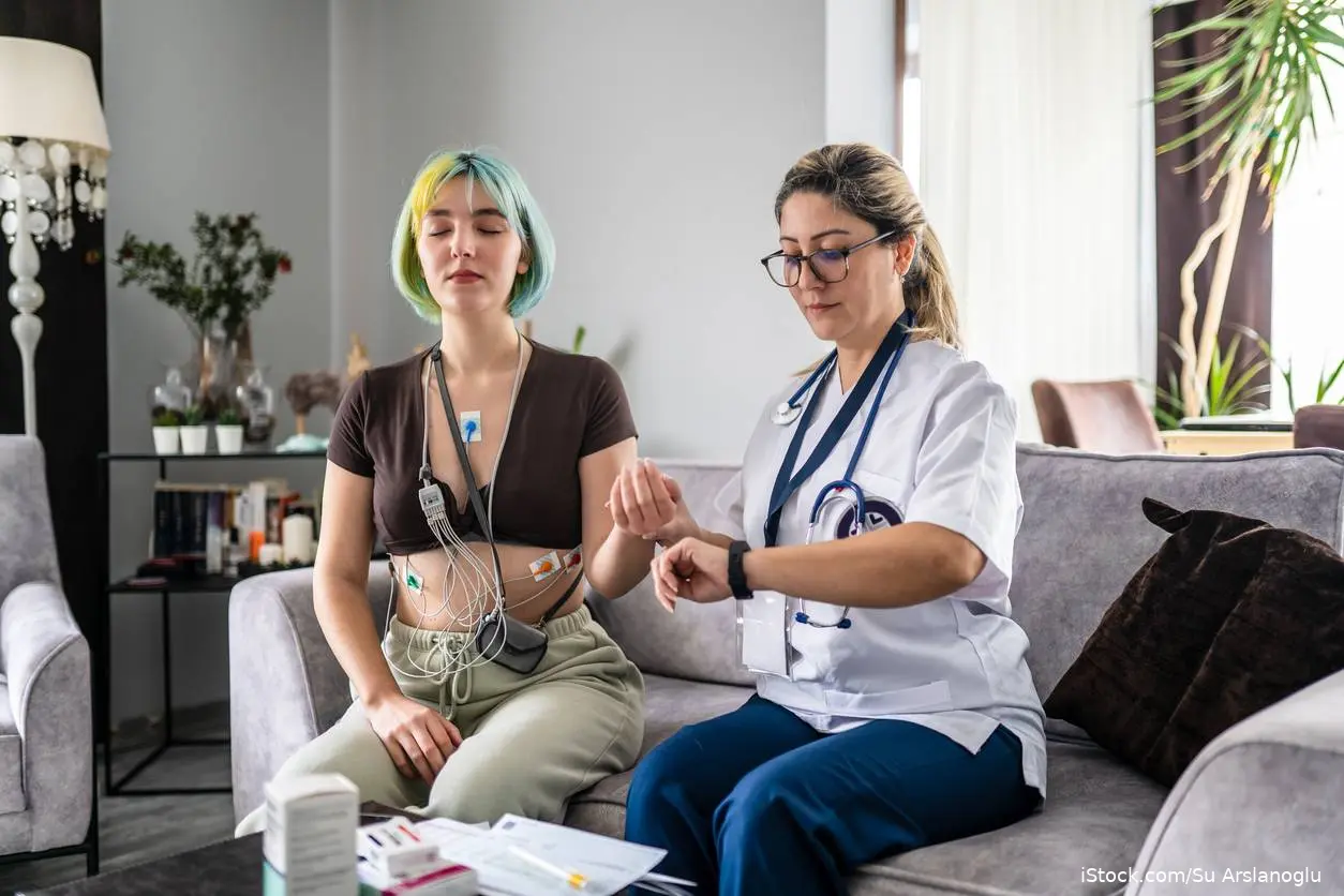 heart monitored by health care worker in patient's home