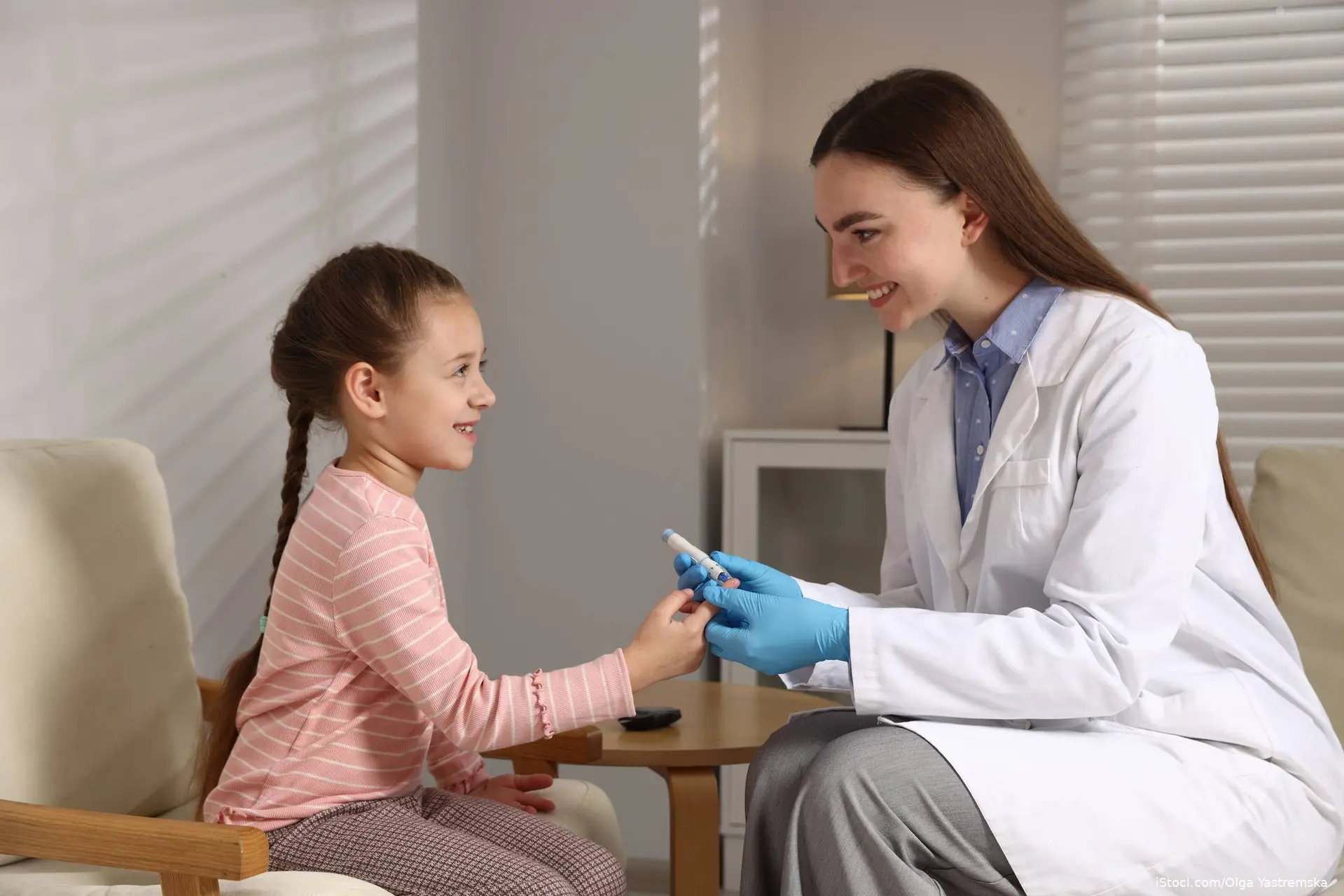 young gorl gettin a finger stick from her doctor