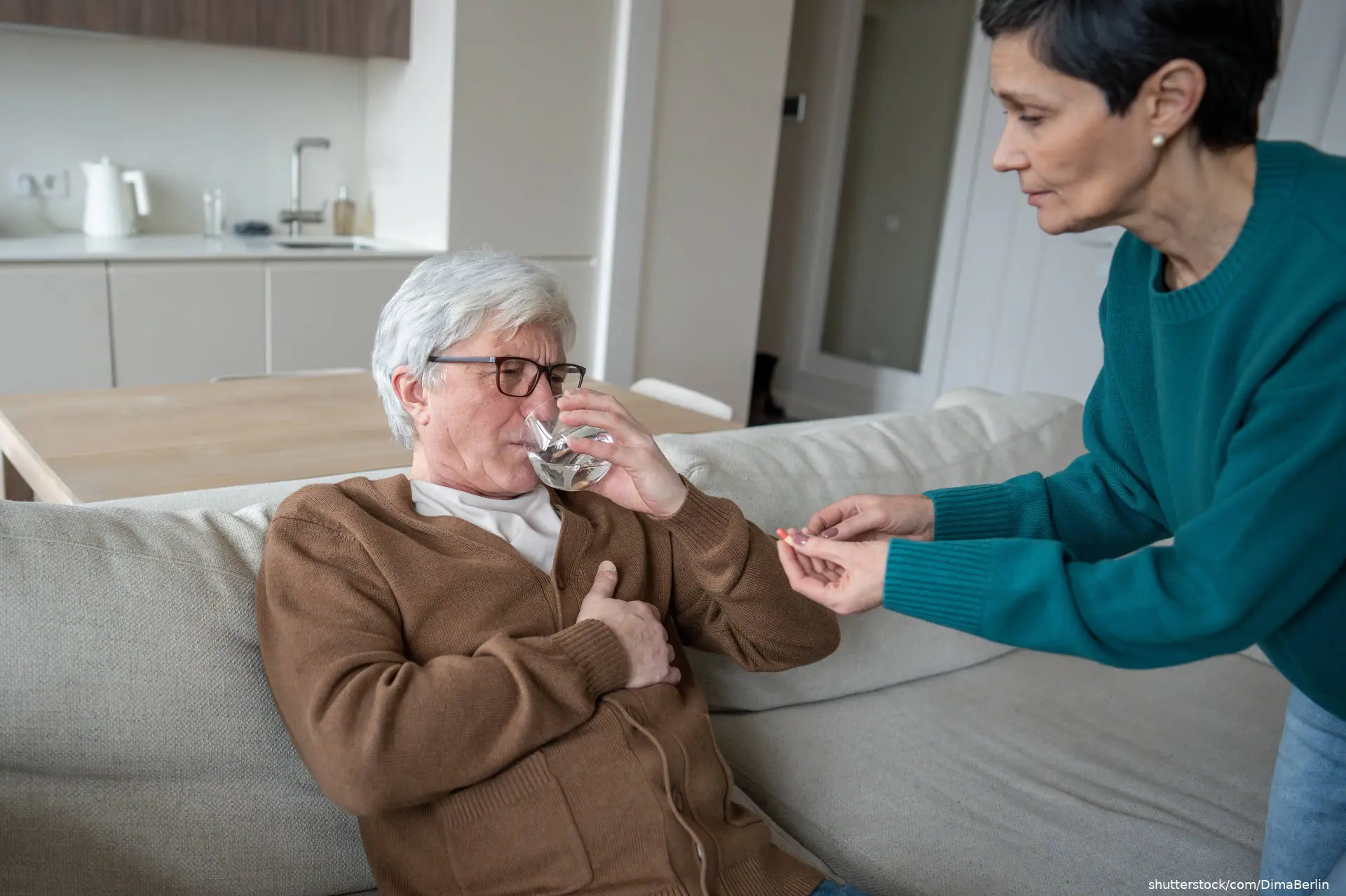 woman helping stroke patient with medication