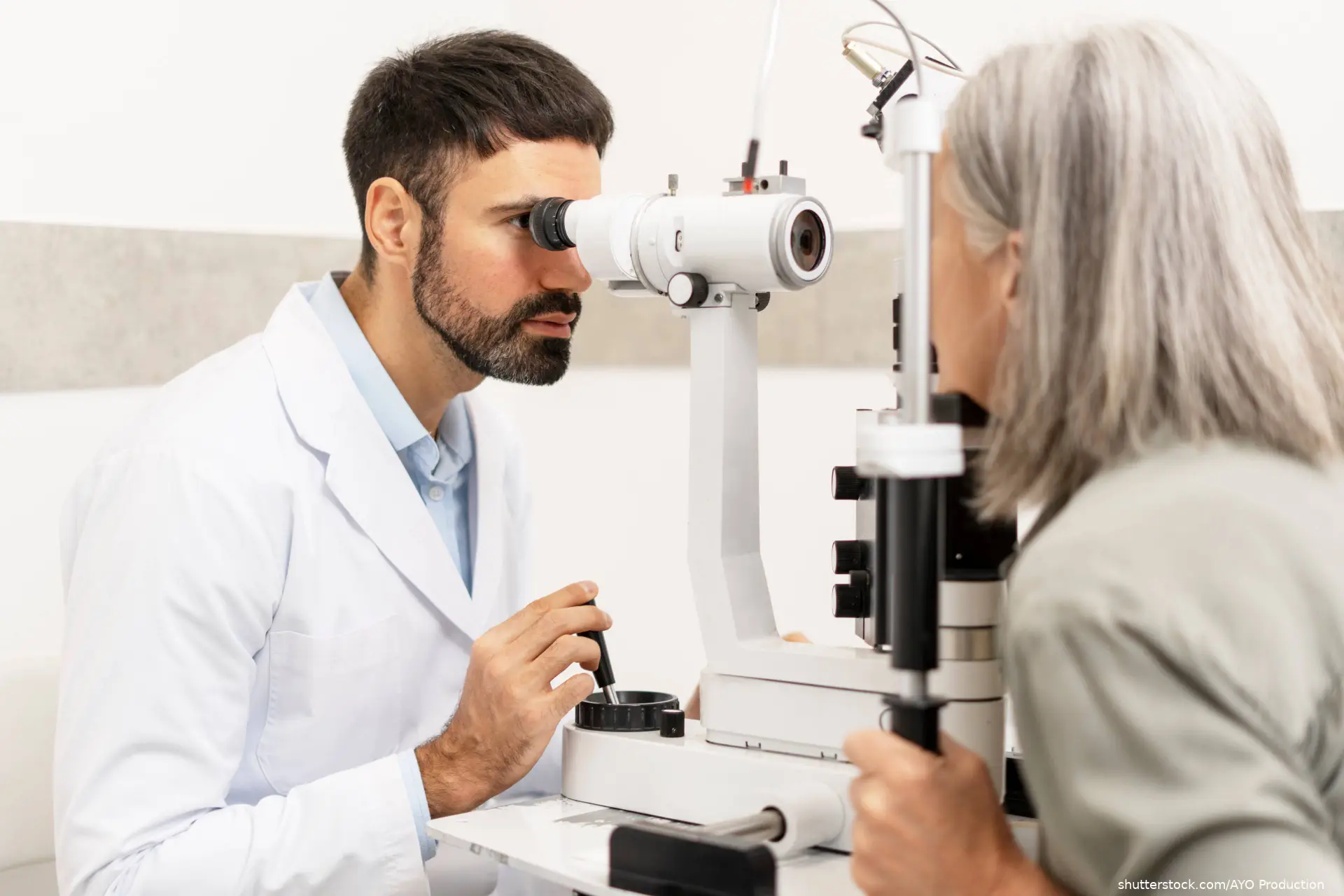 ophthalmologist examining the eyesight of a senior woman