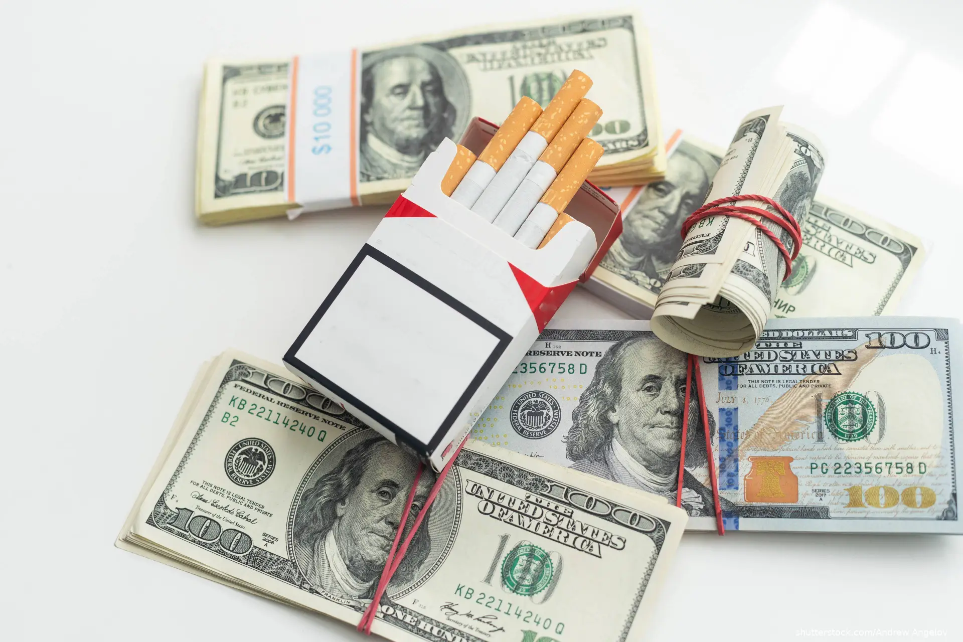 cigarettes lying on the dollar bills