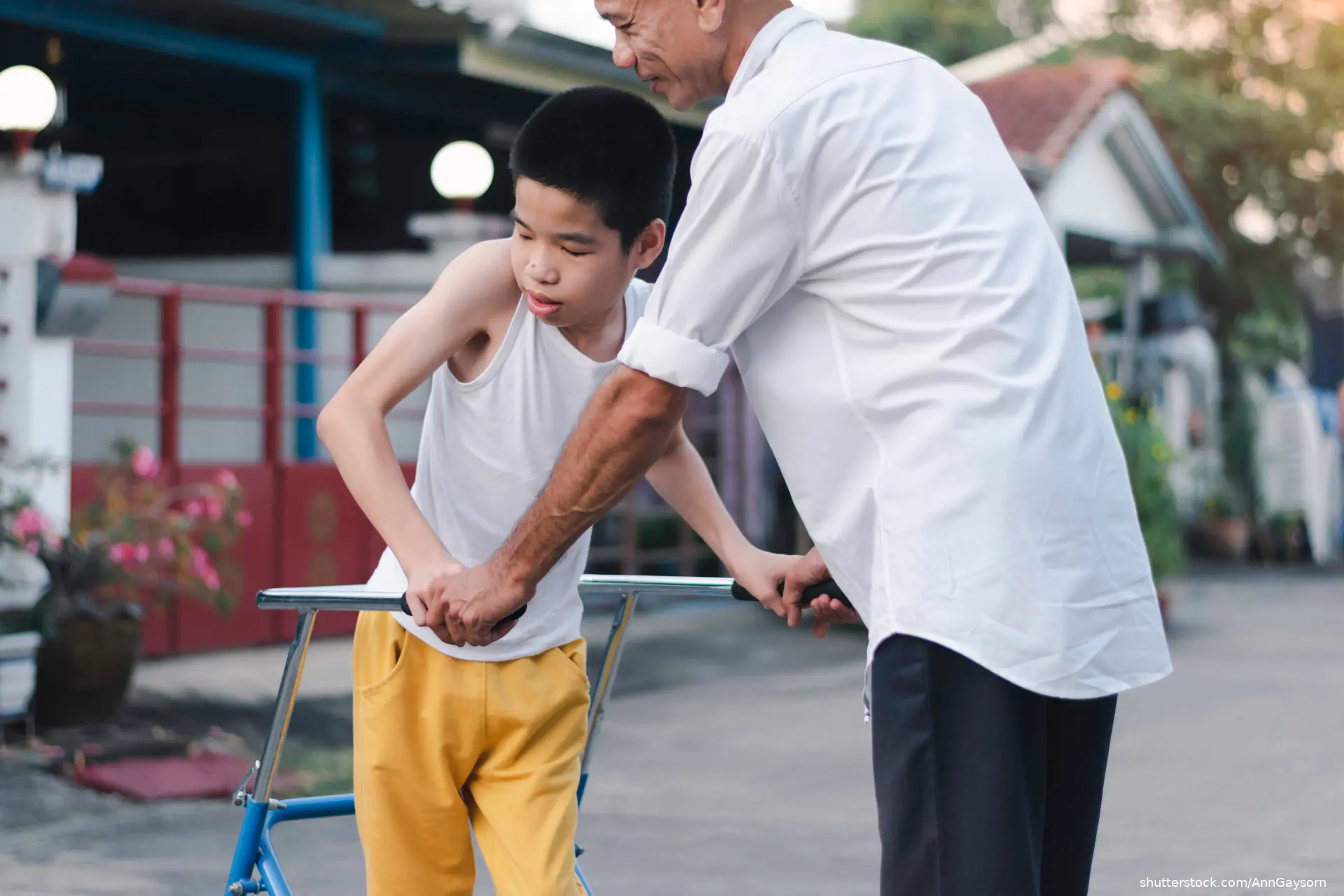 Disabled child is doing physical with father