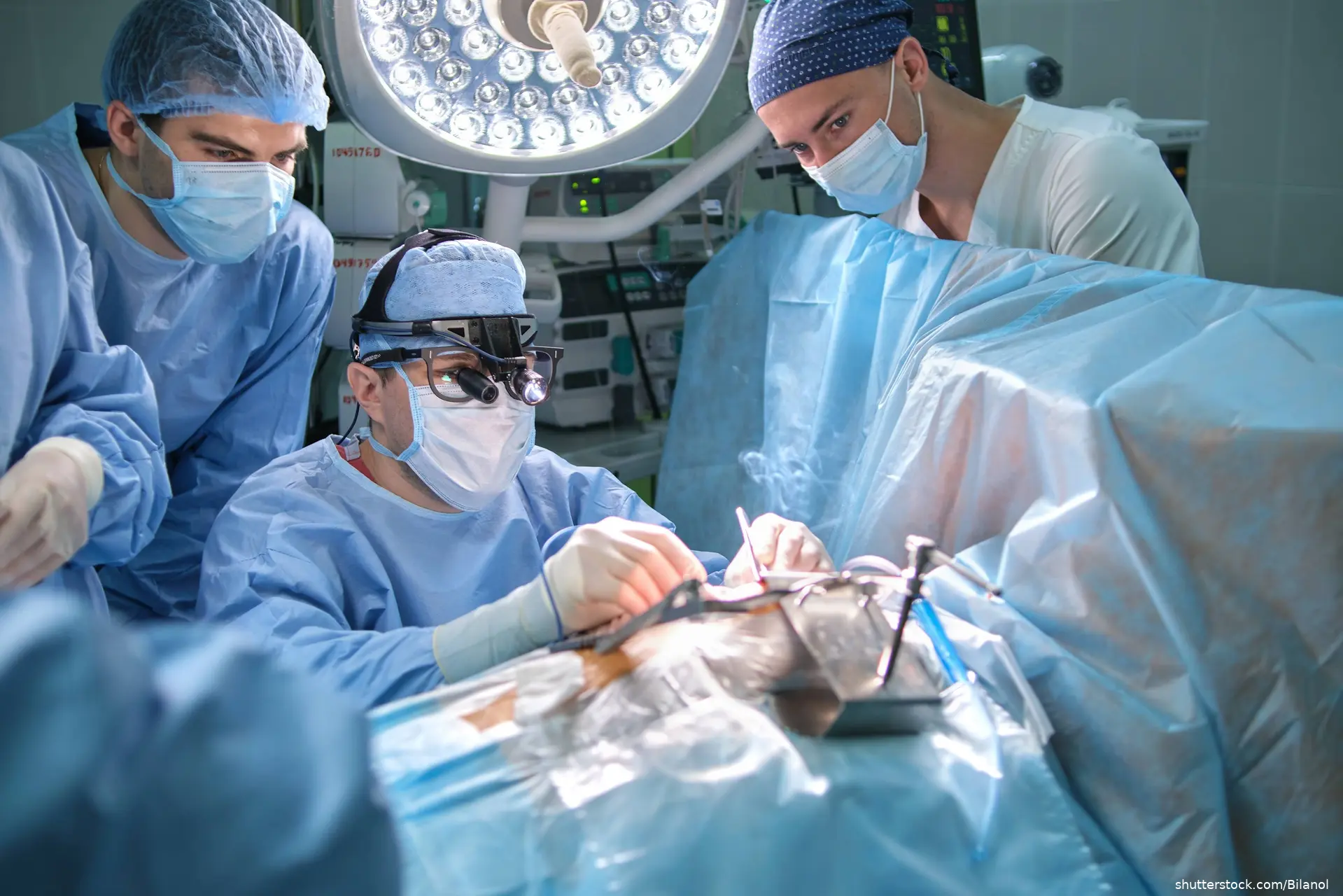 image of doctors performing surgery in OR